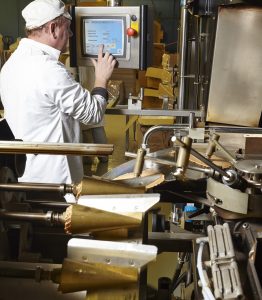 man at screen doing cone production at antonelli bakery
